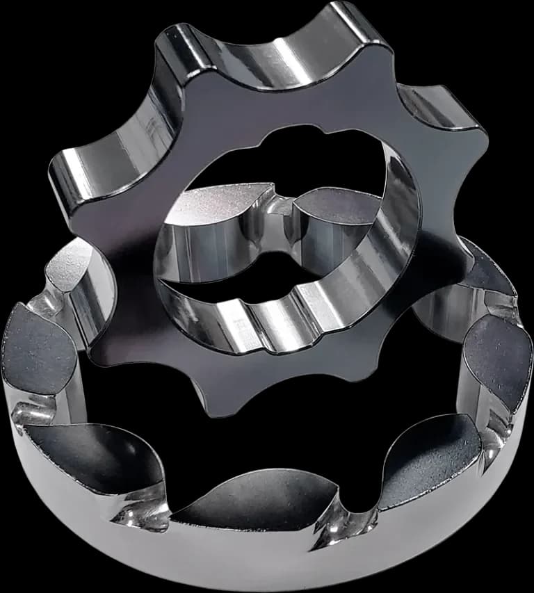 A close-up, dramatic shot of a high-performance Coyote engine block with the front cover removed, highlighting a gleaming, strong billet oil pump gear and crankshaft sprocket assembly. The setting is